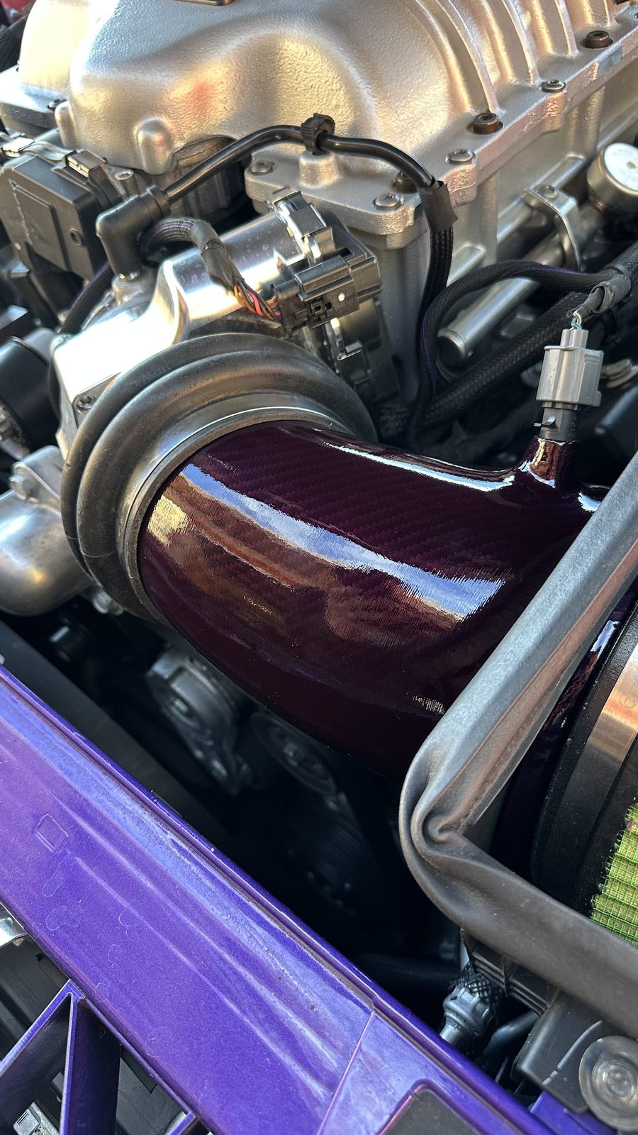 Purple intake tube installed near a green cone filter
